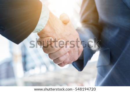 Hand shake of two businessman with sun flare, business conceptual
