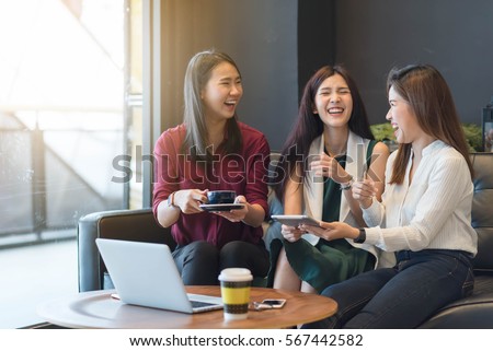 3 teenagers friends meet in coffee shop, using technology device have fun