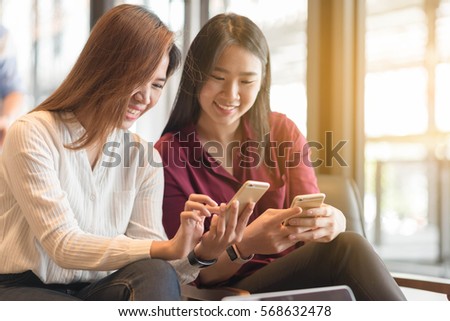 Two woman using smartphone sharing data, iot, internet of things conceptual