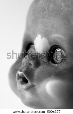 Portrait of a dirty doll face in black and white