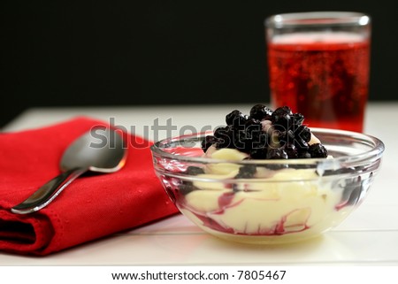 Rich blueberry pudding for dessert on a white table with red accents