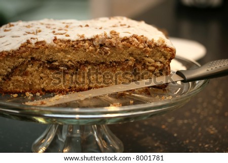 A freshly baked coffee cake on a glass platter