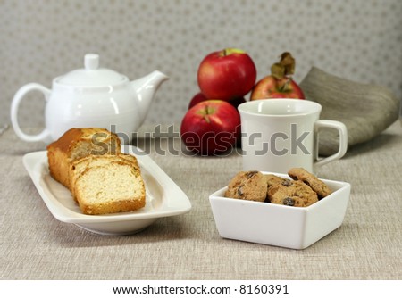 A dessert table with cookies, cake and tea