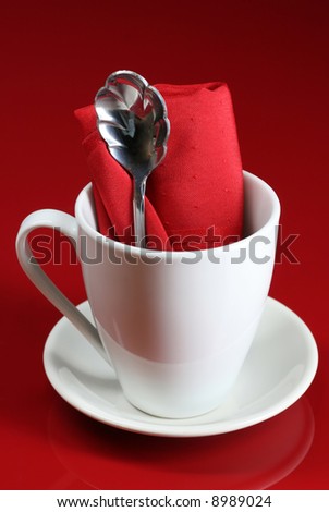 A modern coffee cup on a red cafe table
