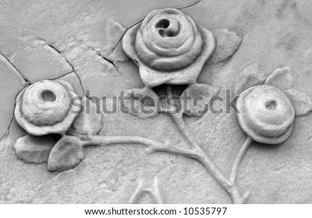 Roses carved into a gravestone in black and white