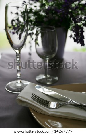 A table set for a quiet dinner in a dark restaurant