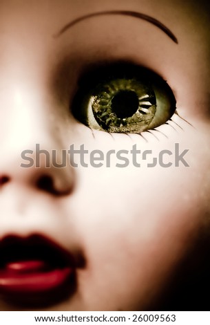 A doll\'s blue eye and red lips