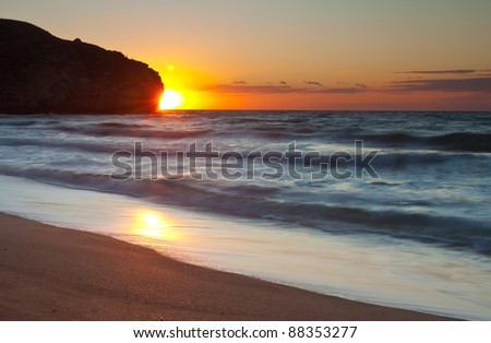 Sun setting over the sea at the beach background