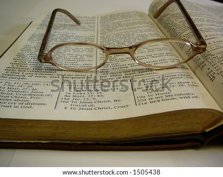 Open Study Bible With Eye Glasses on Top