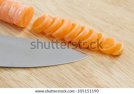 Carrot sliced on wooden chopping board