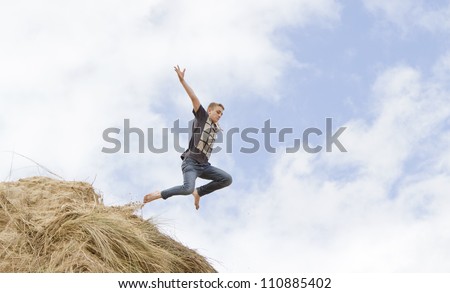 Teenage boy jumping off a sand dune