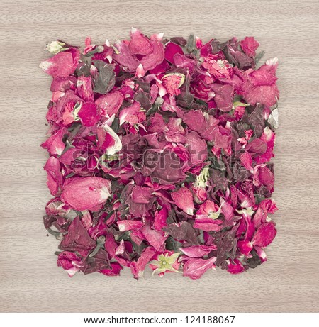 Dried rose petal pot-pourri on wooden background
