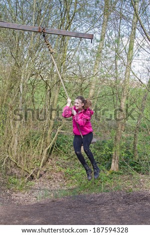 Girl swinging around on a rope swing