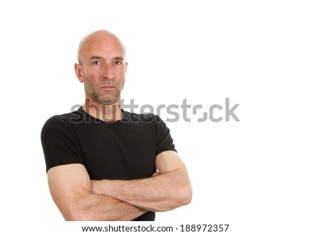 Man in black tee-shirt posing with arms folded