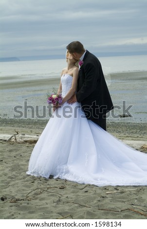 stock photo Wedding couple kissing on the beach