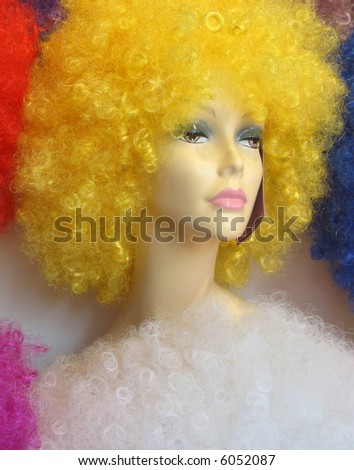 Crazy yellow wig on a model wigblock