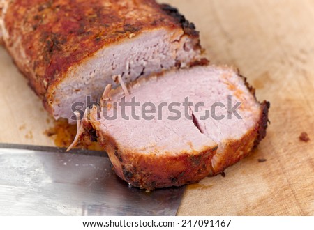 Roast pork on cut board.
