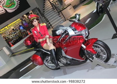 BANGKOK, THAILAND- MARCH 29: Unidentified female presenters with Honda  motorcycle  on display at  the Bangkok International Motorshow 2012 on March 29, 2012 in Bangkok,Thailand