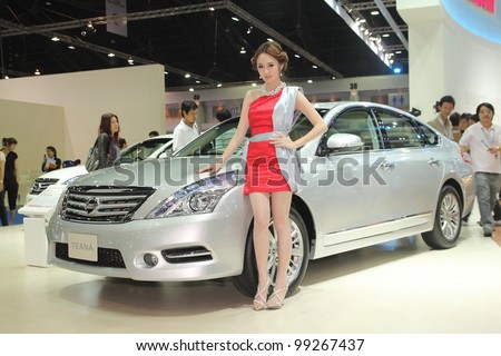 BANGKOK, THAILAND-APRIL 3: Unidentified female presenter with Nissan Teana car on display at  the Bangkok International Motorshow 2012 on April 3, 2012 in Bangkok, Thailand