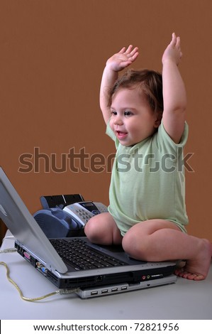 I did it! Baby sitting at her laptop, raising her arms as it to be finishing a project she had worked hard on.