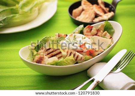 Chicken Caesar salad with poached egg, grilled chicken, lettuce, croutons caesar dressing