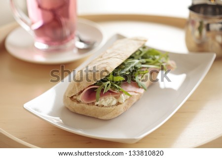 Continental breakfast with sandwich and tea. Shallow DOF