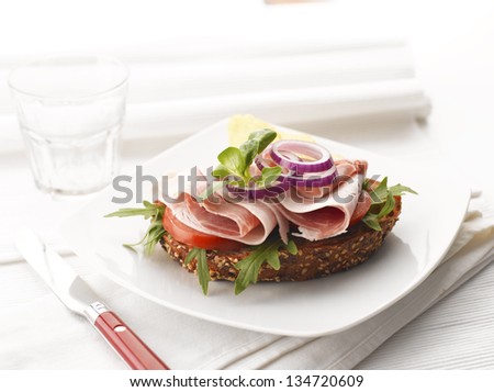 Turkey and Ham Sandwich with Potato Chips. White background, shallow focus.