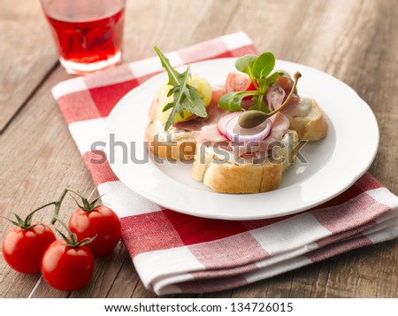 Turkey and parma ham canapes (sandwiches) with tomato, onion, caper and raspberry drink