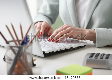 Close-up of businesswoman working on accountancy  with laptop. Small business.