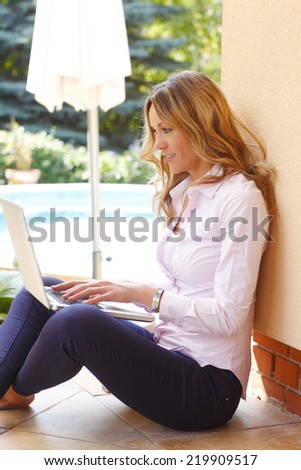 Portrait of casual businesswoman making her presentation while sitting at garden at home.