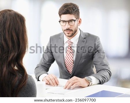 Financial advisor giving advise to business woman while sitting at office. Teamwork.