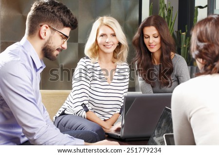 Portrait of smiling mature business woman sitting at meeting. Teamwork at office.