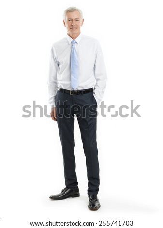 Full length portrait of senior businessman standing against white background.