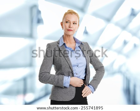 Portrait of executive sales woman standing at office. Business people.