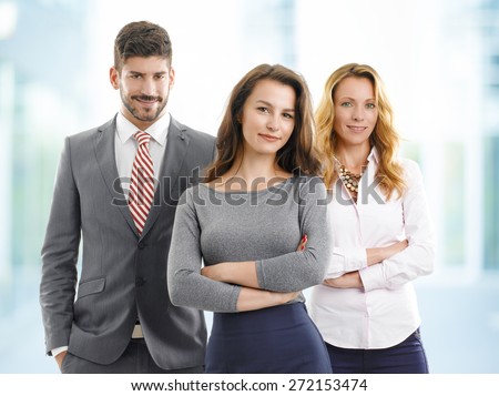Portrait of efficiency sales team standing at office. Young businessman and businesswoman standing with middle age sales woman and looking at camera.