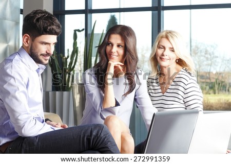 Business team at office. Portrait of businesswomen and businessman sitting at desk in front of computer and consulting from financial plan.