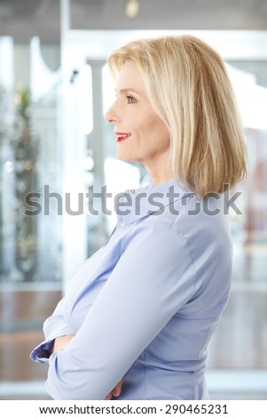 Profile portrait of beautiful businesswoman standing at office.