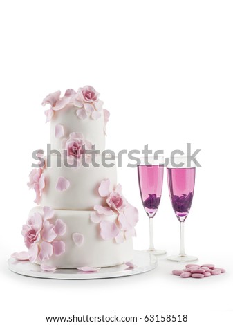 stock photo Luxurious wedding cake with flowers and two champagne flute 