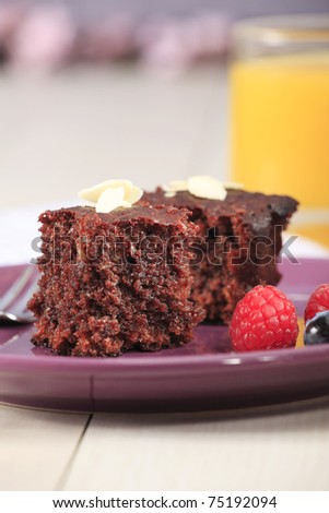 Home-made chocolate cake with strawberreis, blueberries and with orange juice
