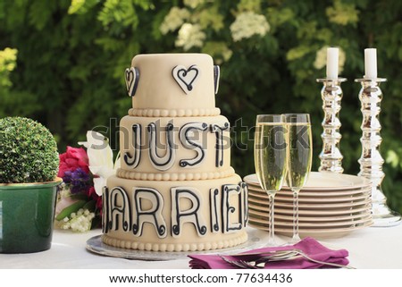 Luxurious wedding cake and two champagne flute glasses on the reception desk