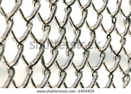 Photo of a chain link fence after an ice storm.