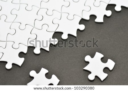 Plain white jigsaw puzzle, on Black background.