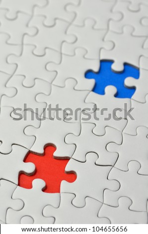 Plain white jigsaw puzzle, on Blue Red background.