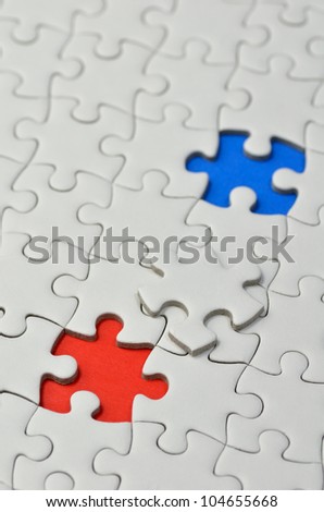 Plain white jigsaw puzzle, on Blue Red background.