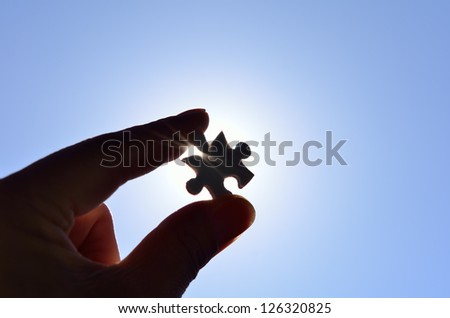 Plain white jigsaw puzzle on Background of blue sky and sun.