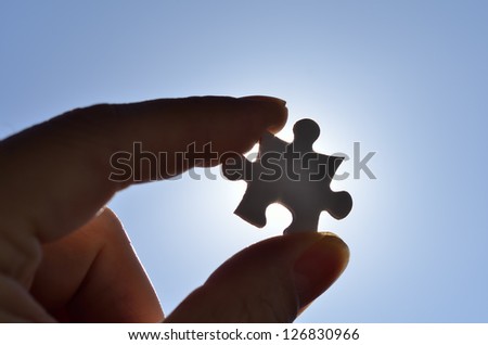 Plain white jigsaw puzzle on Background of blue sky and sun.