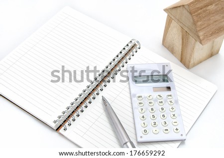 The house of blocks, a calculator, a note, a ball-point.