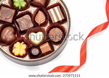 Chocolate gift and Red heart ribbon on white background.