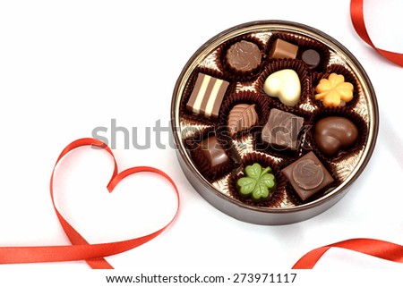 Chocolate gift and Red heart ribbon on white background.