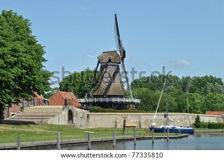 Dutch wind mill at water side